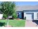 Attractive house exterior with a gray facade, two-car garage, and lush green lawn at 2825 Attwater Loop, Winter Haven, FL 33884