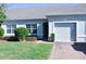 Well-maintained light blue house with a two-car garage and neatly landscaped lawn at 2825 Attwater Loop, Winter Haven, FL 33884
