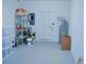 Organized garage with shelving units, water heater, and extra space for storage at 2825 Attwater Loop, Winter Haven, FL 33884