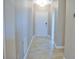 Bright hallway with tile flooring and neutral walls at 2825 Attwater Loop, Winter Haven, FL 33884