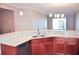 Modern kitchen with light countertops, stainless steel appliances, and wood cabinets at 2825 Attwater Loop, Winter Haven, FL 33884