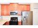 Modern kitchen with stainless steel appliances and ample wood cabinetry at 2825 Attwater Loop, Winter Haven, FL 33884