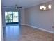 Spacious living room with tile floors and sliding doors to patio at 2825 Attwater Loop, Winter Haven, FL 33884