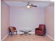 Cozy sitting area with two armchairs and a glass-top coffee table at 2825 Attwater Loop, Winter Haven, FL 33884