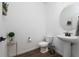 Powder room with pedestal sink and modern toilet at 4381 Davos Dr, Clermont, FL 34711