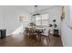 Elegant dining room with a six-seat table and modern light fixture at 4381 Davos Dr, Clermont, FL 34711