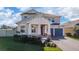 Two-story house with stone accents, a three-car garage, and well-manicured landscaping at 4381 Davos Dr, Clermont, FL 34711