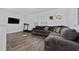 Relaxing living room with L-shaped sofa and large TV at 4381 Davos Dr, Clermont, FL 34711
