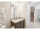 Small bathroom with granite countertop vanity and view of staircase at 471 Lasso Dr, Kissimmee, FL 34747