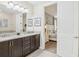 Bathroom with double vanity and view into bedroom at 471 Lasso Dr, Kissimmee, FL 34747