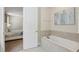 Relaxing bathroom with a soaking tub and view into the bedroom at 471 Lasso Dr, Kissimmee, FL 34747