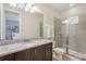 Bathroom with granite countertop, large mirror, and shower at 471 Lasso Dr, Kissimmee, FL 34747