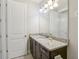 Bathroom with granite countertop, double sinks, and mirror at 471 Lasso Dr, Kissimmee, FL 34747