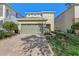 Two-story house with a two-car garage and landscaping at 471 Lasso Dr, Kissimmee, FL 34747