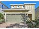 Two-story house with a two-car garage and landscaping at 471 Lasso Dr, Kissimmee, FL 34747