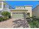 Two-story house with a two-car garage and landscaping at 471 Lasso Dr, Kissimmee, FL 34747
