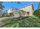 Two-story house with a two-car garage and lush green lawn at 471 Lasso Dr, Kissimmee, FL 34747