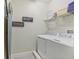 Bright laundry room with washer, dryer, and shelving at 471 Lasso Dr, Kissimmee, FL 34747