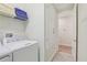 Bright laundry room with washer, dryer, and shelving at 471 Lasso Dr, Kissimmee, FL 34747