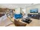 Open living room with kitchen view and a large TV at 471 Lasso Dr, Kissimmee, FL 34747