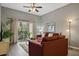 Living room features a comfy couch and access to balcony at 608 Rum Run # 608, Davenport, FL 33897