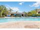 Community pool with lounge chairs and umbrellas at 608 Rum Run # 608, Davenport, FL 33897