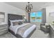 Serene main bedroom with a tufted headboard and water views at 6376 Shimmering Shores Ln, Saint Cloud, FL 34771