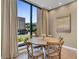 Charming dining area with round table and four chairs, near a large window at 7598 Brooklyn Dr, Kissimmee, FL 34747