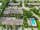 Aerial view of community showing building rooftops, parking, and pool at 7707 Country Pl, Winter Park, FL 32792