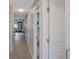 Long hallway with light gray walls and wood-look flooring at 7707 Country Pl, Winter Park, FL 32792