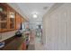 Clean kitchen with wood cabinets and view into dining area at 7707 Country Pl, Winter Park, FL 32792