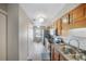 Modern kitchen with wood cabinets, granite countertops, and stainless steel appliances at 7707 Country Pl, Winter Park, FL 32792