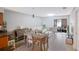 Living room with white sofa, dining table, and access to patio at 7707 Country Pl, Winter Park, FL 32792