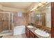 Elegant bathroom with a double vanity, soaking tub, and shower at 903 Charo Pkwy # 836, Davenport, FL 33897