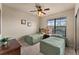 Bright bedroom with two twin beds, ceiling fan, and large window at 903 Charo Pkwy # 836, Davenport, FL 33897