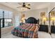 Large main bedroom with a king-size bed and access to balcony at 903 Charo Pkwy # 836, Davenport, FL 33897