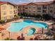 Community pool and spa with surrounding patio at 903 Charo Pkwy # 836, Davenport, FL 33897
