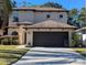 Two-story house with a two-car garage and landscaped lawn at 1720 Crocker Ave, Orlando, FL 32806