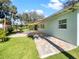 Charming backyard with a brick paved patio, covered seating area, and lush lawn at 2410 Sanford Ave, Sanford, FL 32771