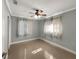 Bright bedroom featuring neutral walls, shiny floors and ceiling fan at 2410 Sanford Ave, Sanford, FL 32771
