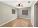 Simple bedroom with light walls, ceiling fan, and neutral decor at 2410 Sanford Ave, Sanford, FL 32771