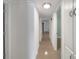 Clean and bright hallway with white walls and light brown tile floors at 2410 Sanford Ave, Sanford, FL 32771