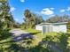 Light teal house exterior with a gravel driveway and a white fence at 2410 Sanford Ave, Sanford, FL 32771