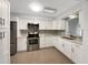 Updated kitchen with white cabinets, stainless steel appliances, and granite countertops at 2410 Sanford Ave, Sanford, FL 32771