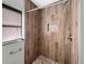 Updated shower with wood-look tile and pebble accents at 2410 Sanford Ave, Sanford, FL 32771