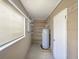 Storage or utility room with shelving and water heater at 2410 Sanford Ave, Sanford, FL 32771