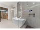 Bathroom with a large soaking tub and a glass-enclosed shower at 2661 Via Tuscany, Winter Park, FL 32789