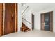 Bright entryway with a wooden staircase and modern doors at 2661 Via Tuscany, Winter Park, FL 32789