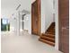 Elegant entryway with a stunning wood staircase and feature wall at 2661 Via Tuscany, Winter Park, FL 32789
