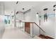 Modern hallway with glass railing and wood staircase at 2661 Via Tuscany, Winter Park, FL 32789